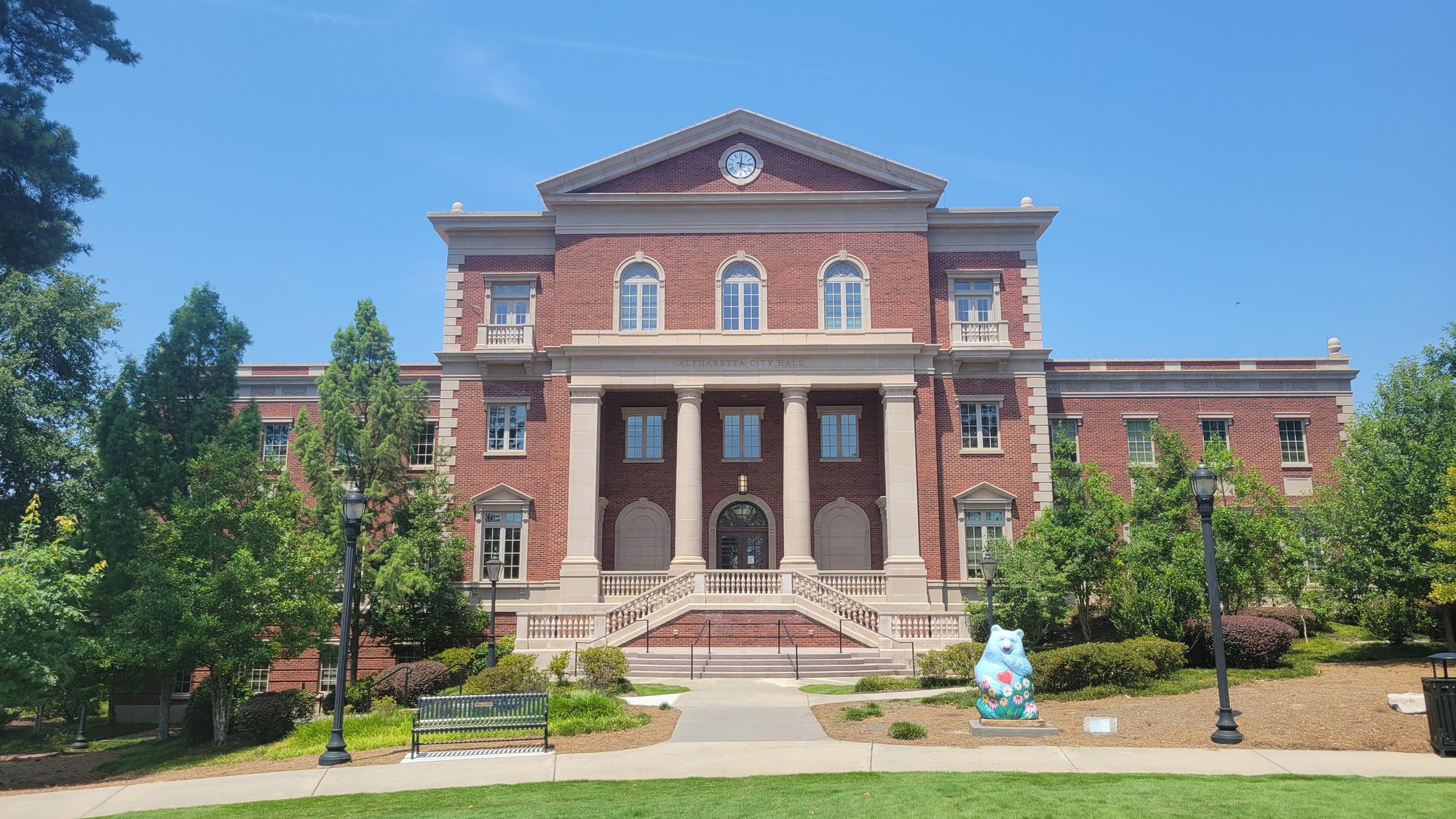 Alpharetta City Hall, a red-brick building with white columns, behind a green lawn