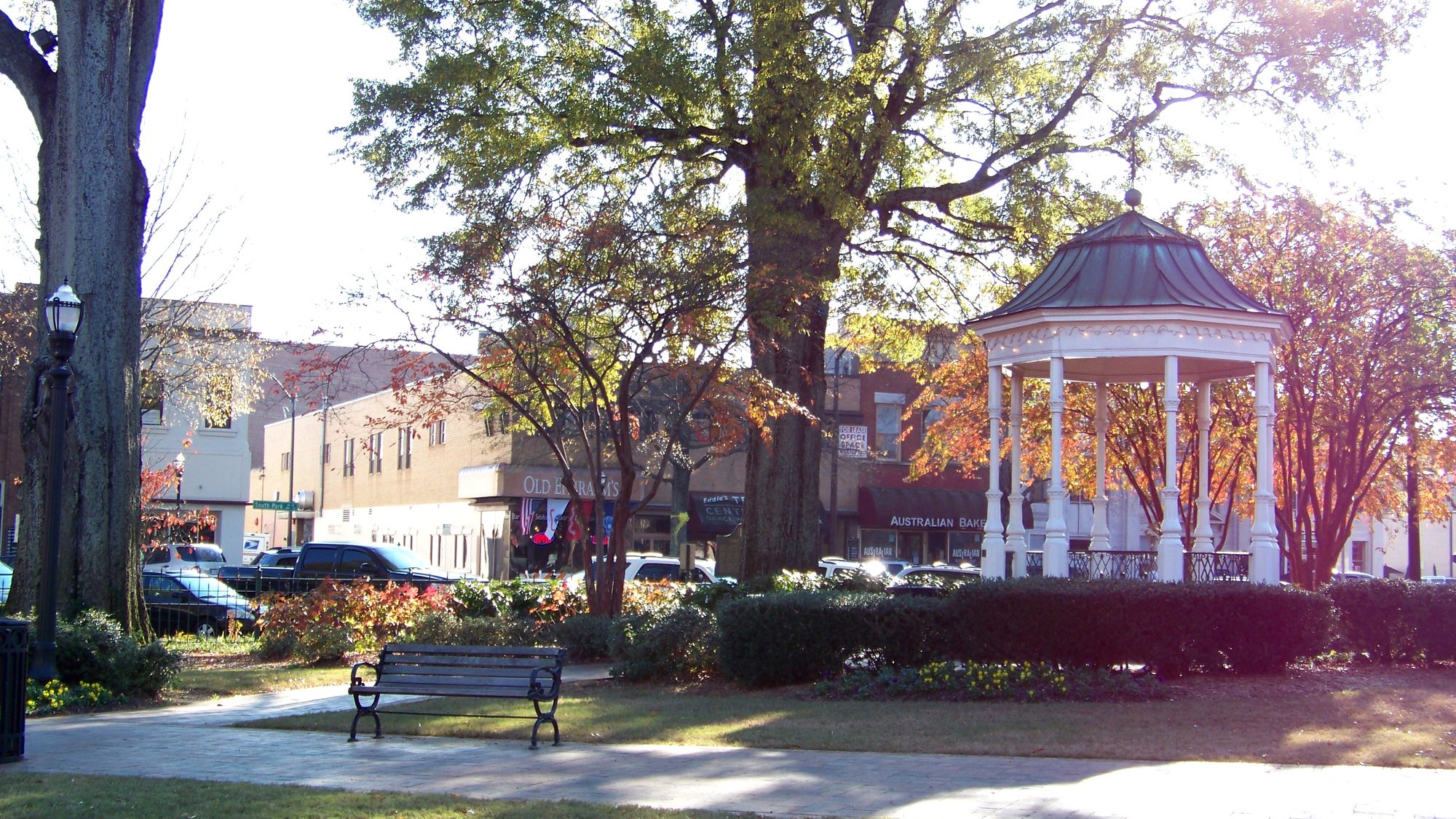 The white gazebo in Glover Park on Marietta Square under autumn trees