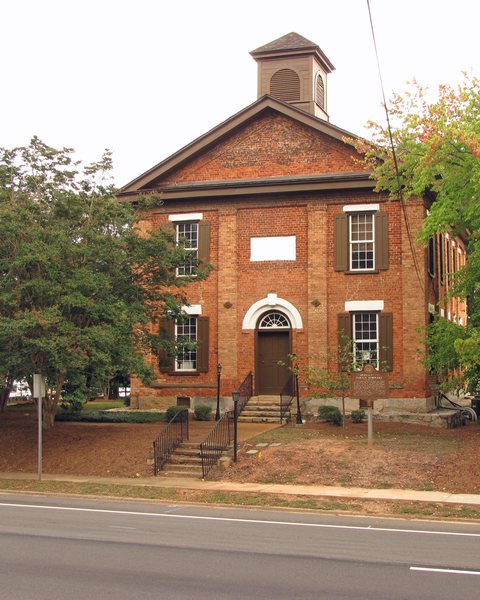 The old Lawrenceville Female Seminary, a red-brick building with a cupola, among trees